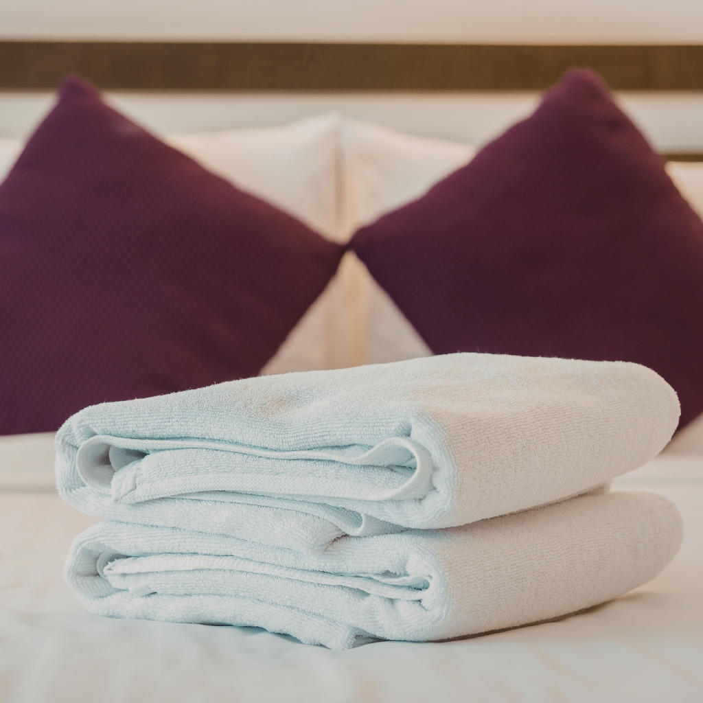 cotton towels on a hotel bed
